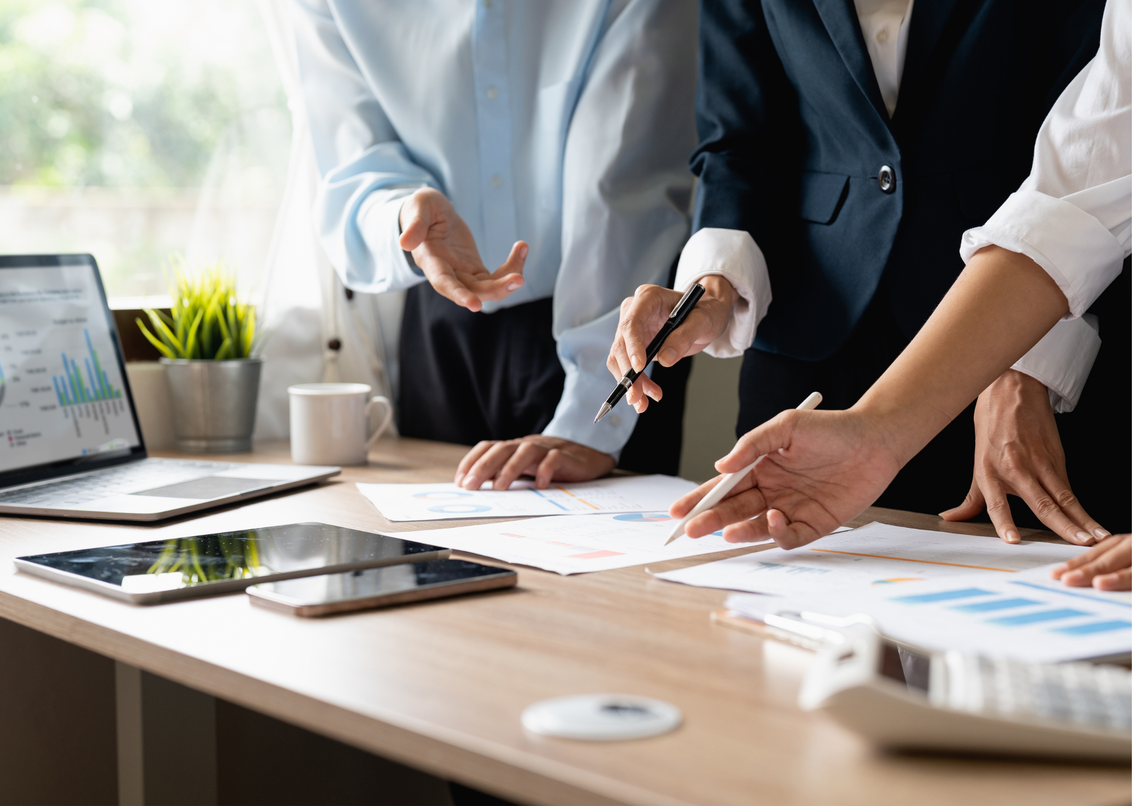 Several professionals working collaboratively at a desk